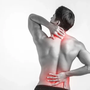 Close up of man rubbing his painful back isolated on white backg Close up of man rubbing his painful back isolated on white background.